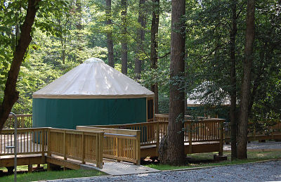 A photo of a Yurt, an enclosure that is part building part tent. This one is is in a Virginia State Park. 