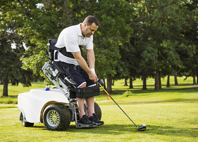 Disabled golfer in a tournament using high tech mobility aid; Edmonton, Alberta, Canada