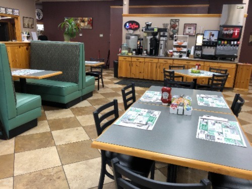 Photo of Mac's Cafe cozy dining area, booths, tables, chairs, and a soft drink coffee beverage bar.
