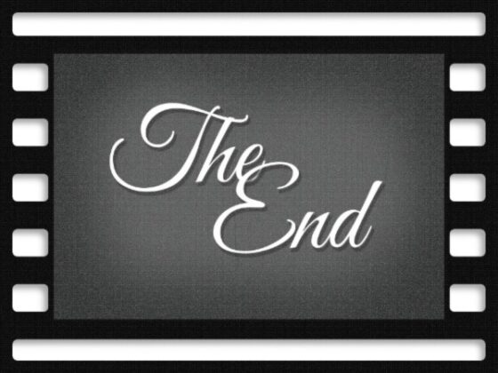 Image of old fashioned black camera film depicting a gray and white scene of fancy font saying "The End" 