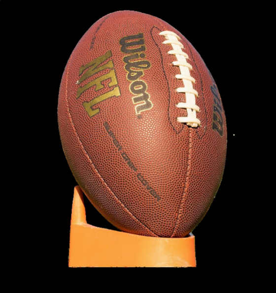 Photo of the NFL Wilson football on a yellow kick stand.