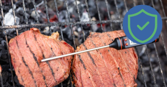 Canva image meat cooking on the grill with a meat thermometer and a blue and green graphic of a check marked shield to symbolize safety. 