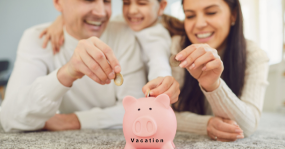 Photo of a young caucasian family: mom, dad, daughter placing coins in a pink piggy bank for a vacation fund. 