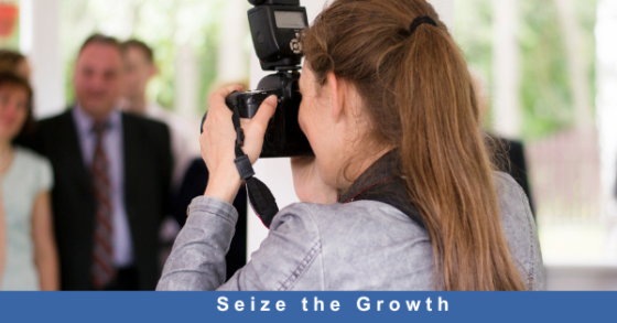 Photo of a female photographer with Caucasian skin taking pictures at an event text "Seize the growth"